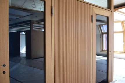 Raummodul mit Glastüren und Schlitzplatten-Wandfeld, im Hintergrund Dachfenster – IHK Nürnberg