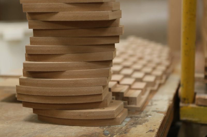 Gestapelte Holzplatten zur Verbesserung der Raumakustik in einem Staudigel-Projekt.