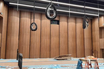 Saal im Bau mit Holzfurnier-Wandpaneelen, Podest und Arbeitsböcken – Beethovenhalle Bonn